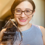 Maria Baimas-George, MD, MPH holding award