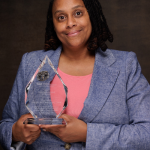 Erica Wilson holding award